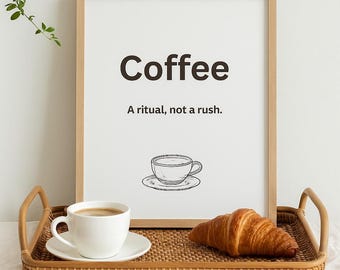 May include: A framed print with the word "Coffee" and the phrase "A ritual, not a rush." A white coffee cup and a croissant sit on a woven tray. The print is in a light wood frame.