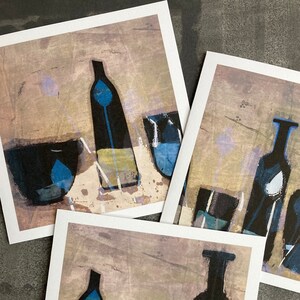 May include: Three abstract paintings of still life with blue and black bottles, glasses, and bowls on a beige background.
