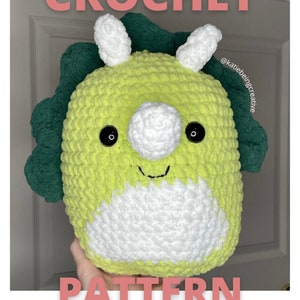 May include: Crochet pattern for a green and white triceratops amigurumi toy. The pattern is available for download and is not a physical item. @katiebeingcreative