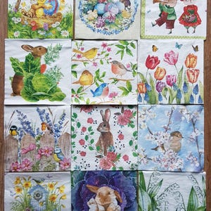 May include: A selection of square paper napkins with Easter-themed illustrations. The napkins showcase bunnies, chicks, eggs, flowers, and birds in bright colours. The designs include spring scenes and floral arrangements.