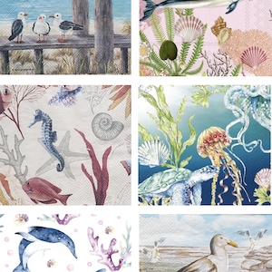 May include: A collection of six square paper napkins featuring various marine themes including seagulls on wooden posts, a dolphin with a seahorse, underwater sea life with a turtle and jellyfish, and blue dolphins swimming among coral reefs.