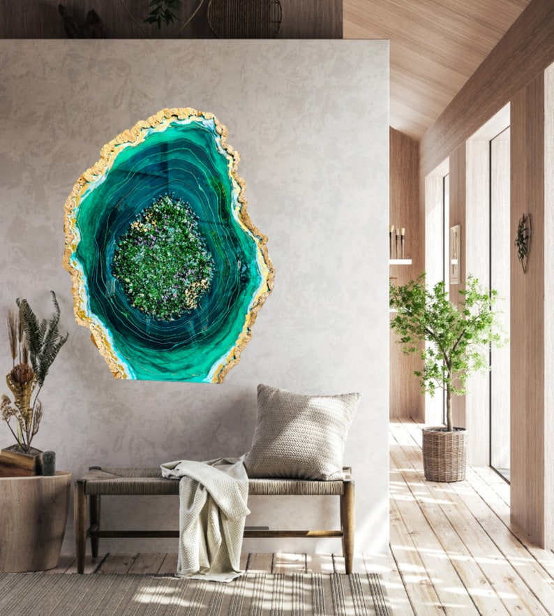 May include: A green and gold resin art piece with a swirling pattern resembling a geode. The art piece is mounted on a wall in a modern home interior.