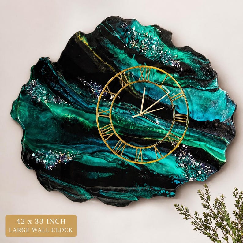 May include: Large wall clock, 42 x 33 inches, with a unique, organic shape. The clock face is gold-colored with Roman numerals. The background features a swirling pattern of black, teal, and green resin with glitter accents.
