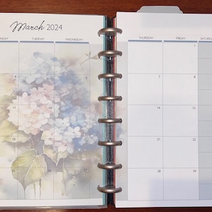 May include: A monthly calendar planner with a watercolor floral design featuring hydrangeas. The calendar is for March 2024 and includes days of the week and numbered dates.