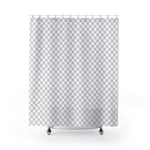 May include: A white shower curtain with a checkered pattern hangs from a silver shower rod. The curtain is made of a soft, water-resistant fabric.