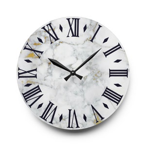 May include: A white marble clock face with black Roman numeral hour markers and black hands. The clock face has a subtle gold veining.