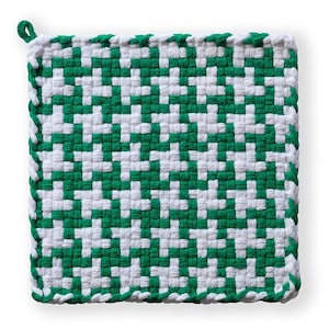 May include: Square, woven potholder in a green and white pattern. The potholder has a loop for hanging and is made of a tightly woven material. The edges are finished with a green and white trim.