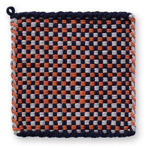 May include: Square woven pot holder with a checkerboard pattern in navy blue, orange, and gray. The edges are trimmed with a navy blue rope and a gray and orange rope. A loop is attached for hanging.