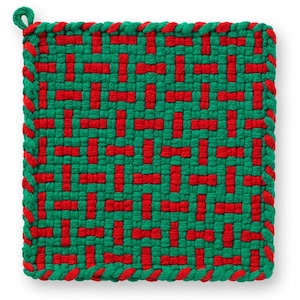 May include: A square, woven hot pad with a green and red geometric pattern. The edges are trimmed with a twisted green and red rope. A small loop is attached to one corner for hanging.