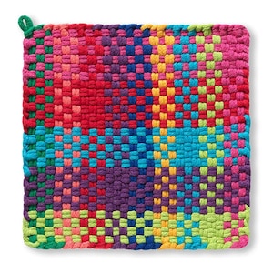 May include: A square, woven hot pad in a vibrant patchwork of colors. The design features sections of red, pink, blue, purple, yellow, and green. A small green loop is attached to one corner for hanging. This kitchen accessory is designed to protect surfaces from heat.
