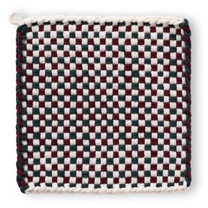 May include: Square woven pot holder with a checkerboard pattern in white, burgundy, and dark green. The edges are trimmed with a dark green and white rope-like border, and a small loop is attached for hanging.