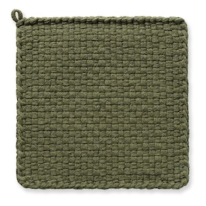 May include: Square, olive green woven pot holder with a loop for hanging. The pot holder is made of a tightly woven material, with a textured surface. The edges are finished with a braided trim.