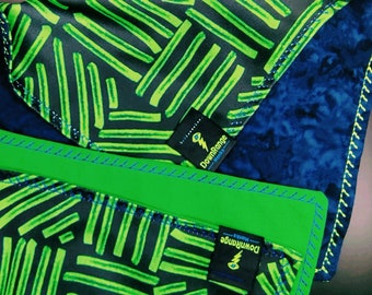 May include: Two black and green patterned fabric squares with a green border and a blue border. Each square has a black label with a lightning bolt and the text "DownRange" on it.