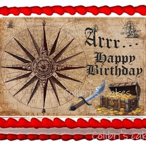 May include: A pirate-themed cake with a red border and a white inner border. The cake features a compass rose, a pirate ship, a sword, a treasure chest filled with gold coins, and the words "Arr... Happy Birthday."