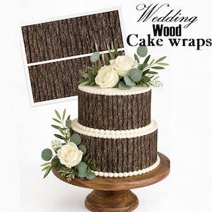 May include: A two-tier cake decorated with a brown wood grain pattern wrap, featuring white rose and eucalyptus floral accents on the top and side. The text "Wedding Wood Cake wraps" appears in the upper right corner of the image.