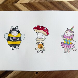 Ilustración de acuarela de desfile de disfraces de gato / pintura de lindo gatito de Halloween