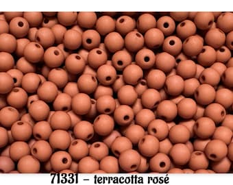 May include: A collection of numerous small, round, matte terracotta rose-colored beads, each featuring a central hole for threading. The text 71331 – terracotta rosé is printed in black at the bottom of the image.