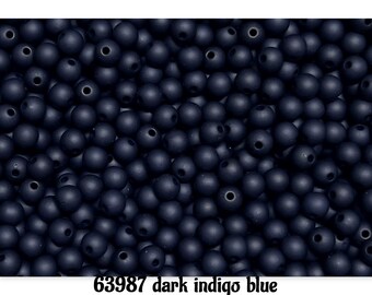 May include: A collection of small, spherical beads in a dark indigo blue color with a matte finish. Each bead features a central hole for threading. The text 63987 dark indigo blue is printed in black at the bottom of the image.