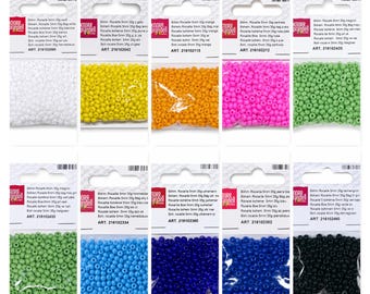 May include: A collection of ten individual plastic bags containing small, round, colored glass beads. Each bag features a white header card with the Knorr Prandell logo, product text, and a unique article number, displaying white, yellow, orange, pink, light green, dark green, light blue, medium blue, dark blue, and black beads.