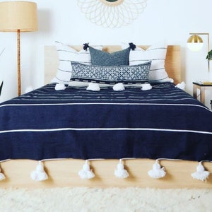 Navy throw with pom poms hotsell