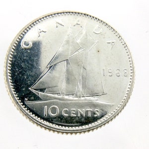 May include: Silver Canadian 10 cent coin featuring a sailing ship and the year 1968.