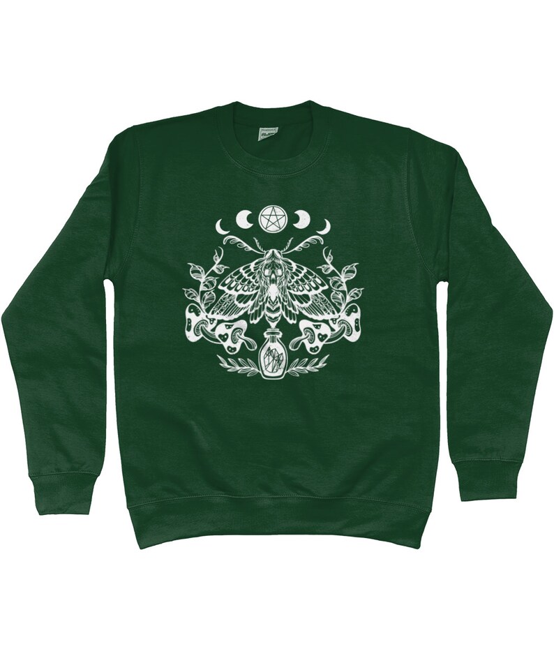 May include: A dark green sweatshirt with a white graphic print of a moth, a pentagram, and crescent moons. The moth is surrounded by leaves and a bottle with a cork.