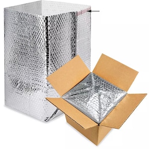 May include: A silver insulated shipping mailer with a cardboard box inside. The mailer is made of bubble wrap and has a silver foil finish. The box is made of brown cardboard and is open to reveal the mailer inside.