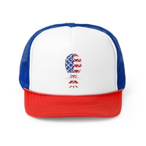 May include: A white trucker hat with a red brim and blue mesh back. The front of the hat features a pineapple design with the American flag colors.