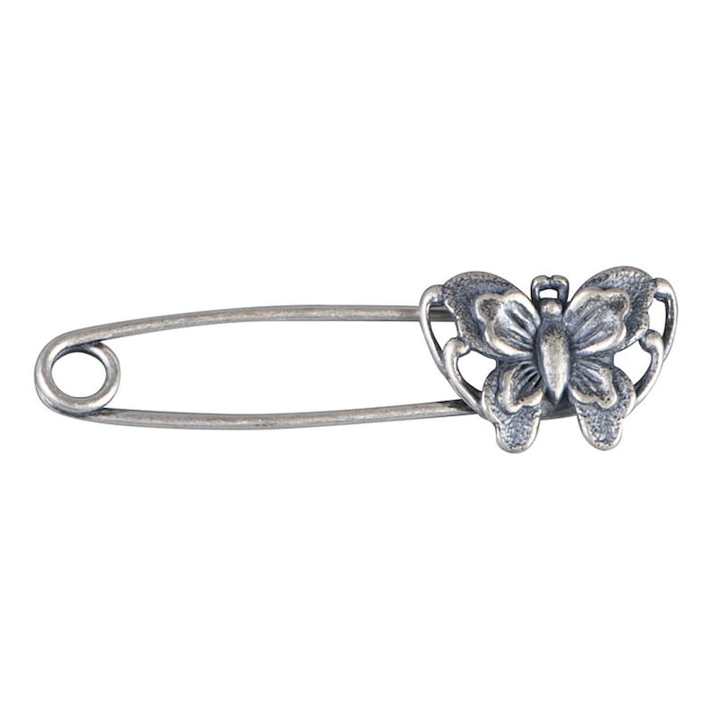 May include: Silver safety pin with a butterfly design. The butterfly is detailed with intricate wings and a body.