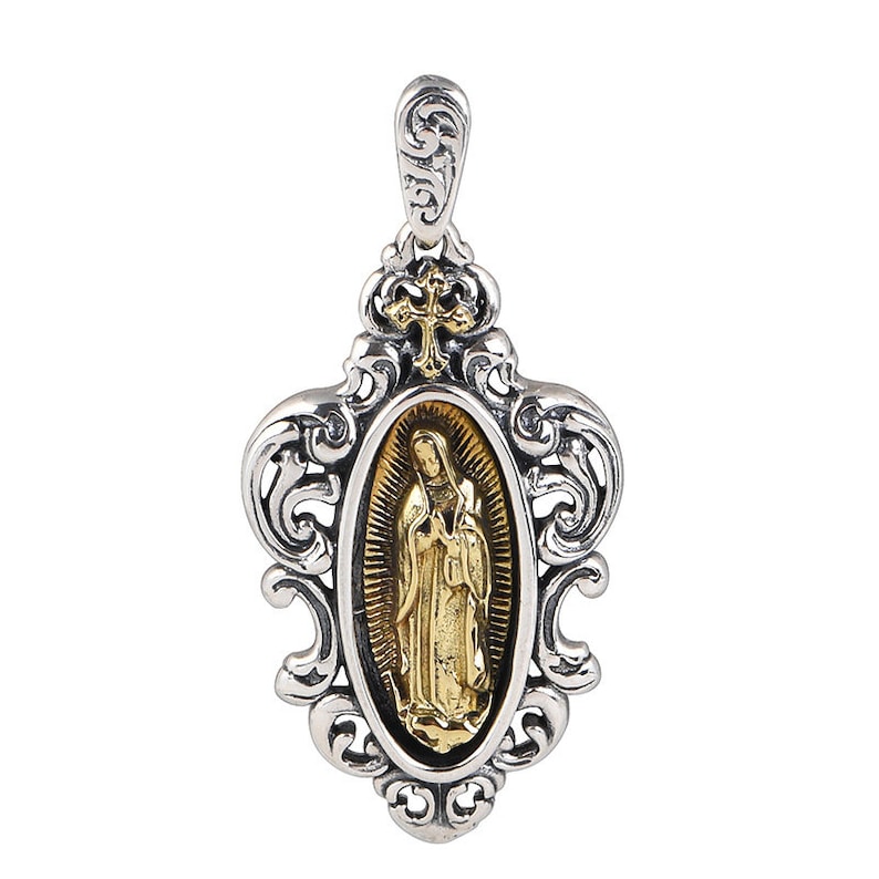 May include: A silver pendant with an ornate design features a gold oval medallion with an image of the Virgin Mary. The pendant has a loop at the top for attaching to a chain.