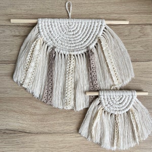 Boho Ibiza style macrame semi lunar with lace ribbons half circle wall hanging in natural colors on a wooden stick