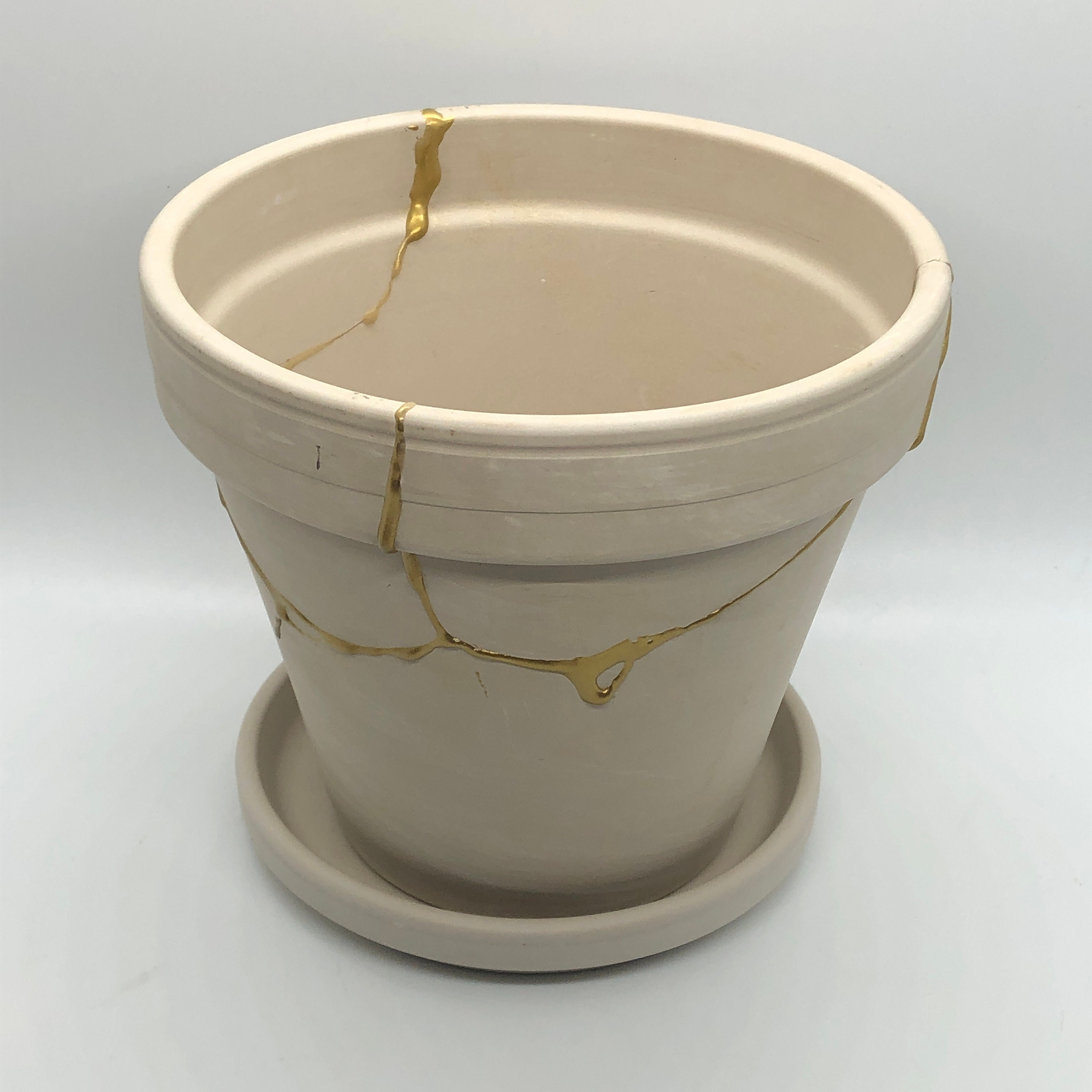 DIY Kintsugi - Broken bonsai pot repaired with gold colored powder