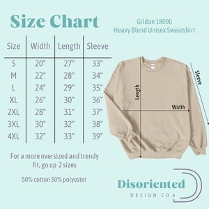 May include: Size chart for a Gildan 18000 Heavy Blend Unisex Sweatshirt. The chart shows the width, length, and sleeve length in inches for sizes S through 4XL. The chart also includes the text "For a more oversized and trendy fit, go up 2 sizes" and "50% cotton 50% polyester".