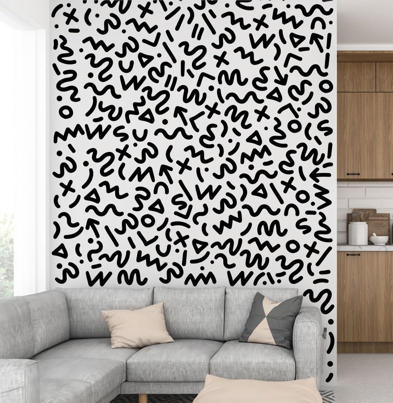May include: A white wall with a black and white abstract pattern of squiggles, lines, and shapes. The pattern is a modern and minimalist design.