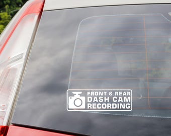 May include: White sticker on a car window that reads "Front & Rear Dash Cam Recording". The sticker features a white camera icon.