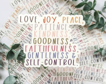 May include: A white sticker with the words "Love, Joy, Peace, Patience, Kindness, Goodness, Faithfulness, Gentleness & Self-Control" written in different colors. The words are arranged in a vertical column.