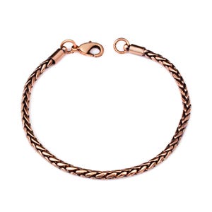 May include: A copper-toned bracelet featuring a woven wheat chain design. The bracelet is constructed with a polished metallic finish and includes a secure lobster claw clasp mechanism at one end, allowing for easy attachment to the circular ring.