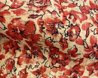 May include: Red and black floral pattern printed on cork fabric. The fabric has a natural, textured surface.
