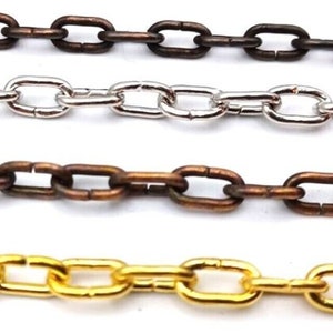 May include: Four chains in different colours: silver, gold, bronze and copper. The chains are all the same style, with oval links.