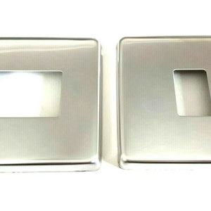 May include: Two silver metal switch plates with rectangular cutouts for light switches.