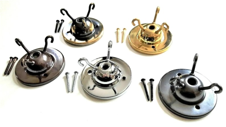 May include: Four ceiling light fixture canopy plates in different finishes: polished brass, chrome, black, and bronze. Each plate has three hooks and comes with screws.