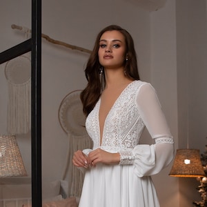 Delicate chiffon wedding dress with French lace - macramé. Dress is complemented by voluminous chiffon sleeves on lace cuffs