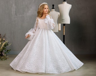 Lush dress with long voluminous tulle sleeves. Communion dress with a glittery floral ornament. White shining dress for the first communion