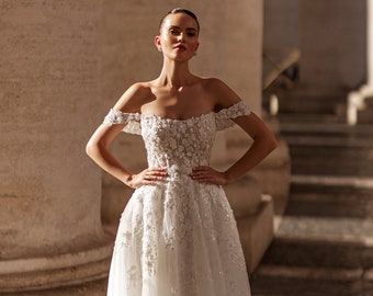 Superbe robe de mariée trapèze en tulle. Robe en dentelle à épaules dénudées. Robe de mariée à corsage fleuri. Élégante robe de mariée ivoire fleurie