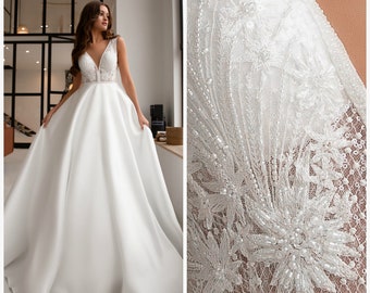 Gorgeous couture wedding dress. Dress with chic lace embroidered with beads and sequins. The skirt is created by high-quality satin