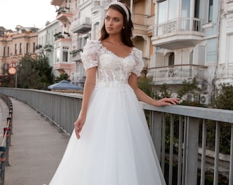 Cinderella's wedding dress. Ivory tulle wedding dress. Wedding lace dress with voluminous short sleeves. Wedding dress with 3D flowers