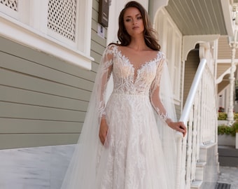 Wedding dress with wings-trains. Ivory wedding dress with sparkling lace. Tulle wedding dress with a lace base Bridal gown with long sleeves