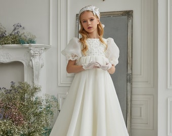 Chiffon communion dress. Ivory children's delicate dress embroidered on a corset with sequins and beads and decorated with lace leaves