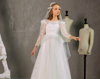 Delicate lace dress made of light tulle. Communion dress in Renaissance style. Dress for the first communion with long sleeves