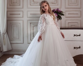 Delightful white dress with a lace floral bodice with sequins, beads and a fluffy tulle skirt with 3D flowers. Dress with long lace sleeves